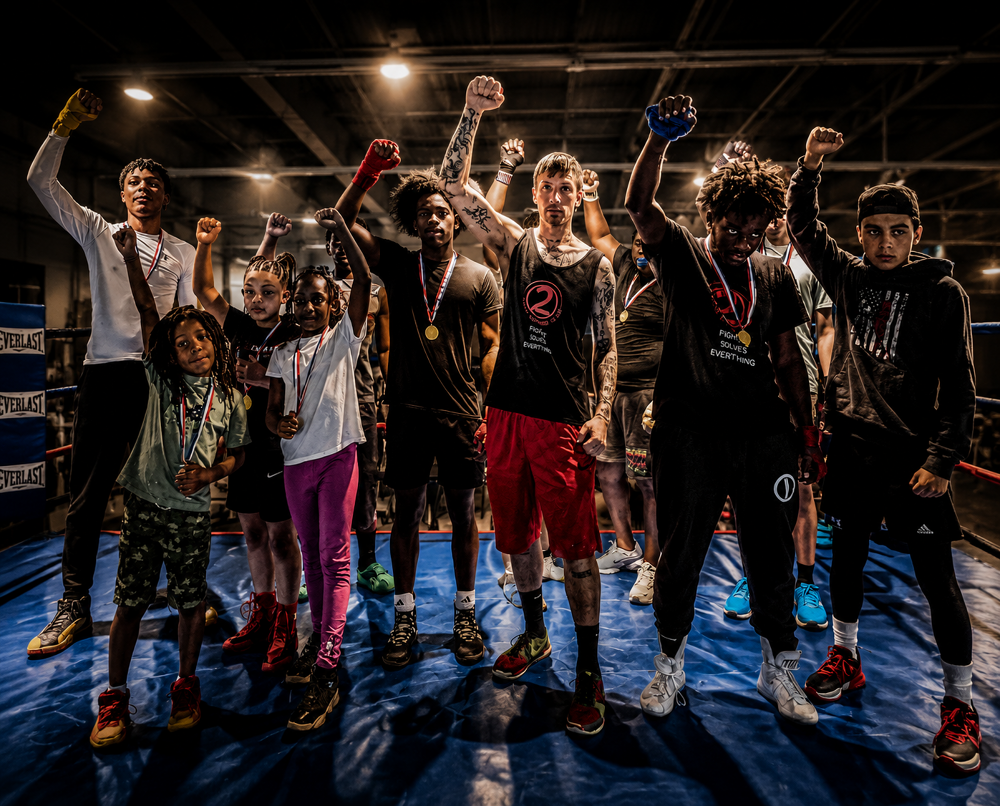 2 Tone teen fighters in the ring with medals