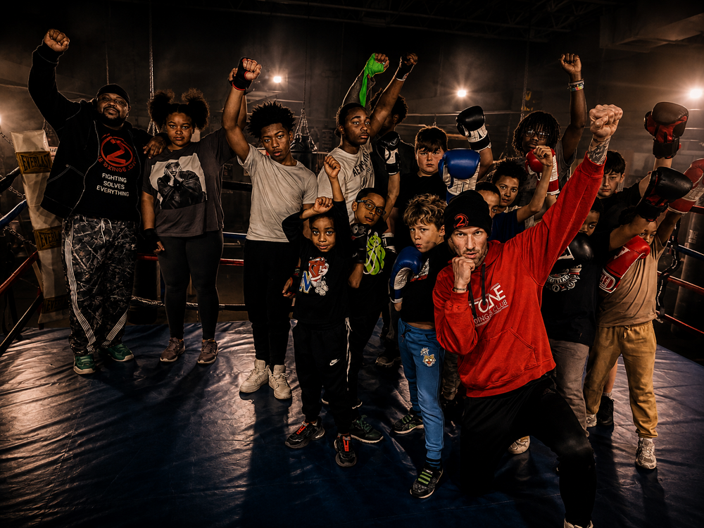 Youth boxers of all ages with fists raised in the 2 Tone ring